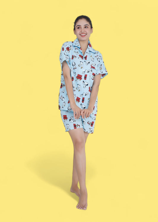 Woman in pastel blue cotton shorts set with Snoopy cartoon print, relaxed loungewear by WakeUp Chicq.