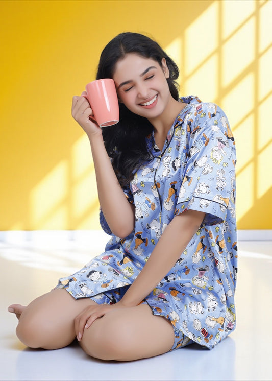 Woman wearing Snoopy blue satin shorts set with cartoon character print shirt and relaxed-fit shorts, glossy nightwear by WakeUp Chicq.