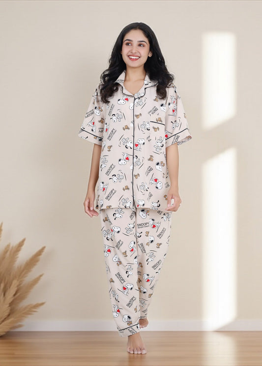 Woman wearing beige crepe cotton pyjama set with Snoopy cartoon print and relaxed oversized fit, by WakeUp Chicq.