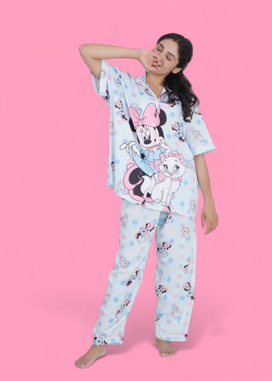 Woman in pastel blue cotton nightwear set featuring Minnie Mouse and cat print, relaxed-fit pyjamas by WakeUp Chicq.