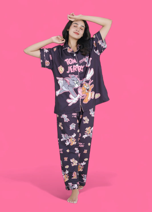 Woman wearing oversized black crepe pyjama set with Tom & Jerry cartoon print, full-sleeve nightwear by WakeUp Chicq.
