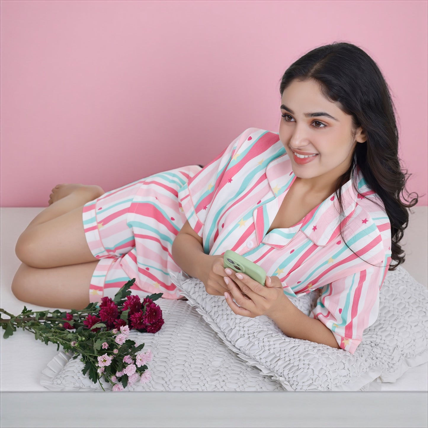 Woman in pastel striped cotton shorts set featuring mini hearts and stars. Soft cotton loungewear for women by WakeUp Chicq.