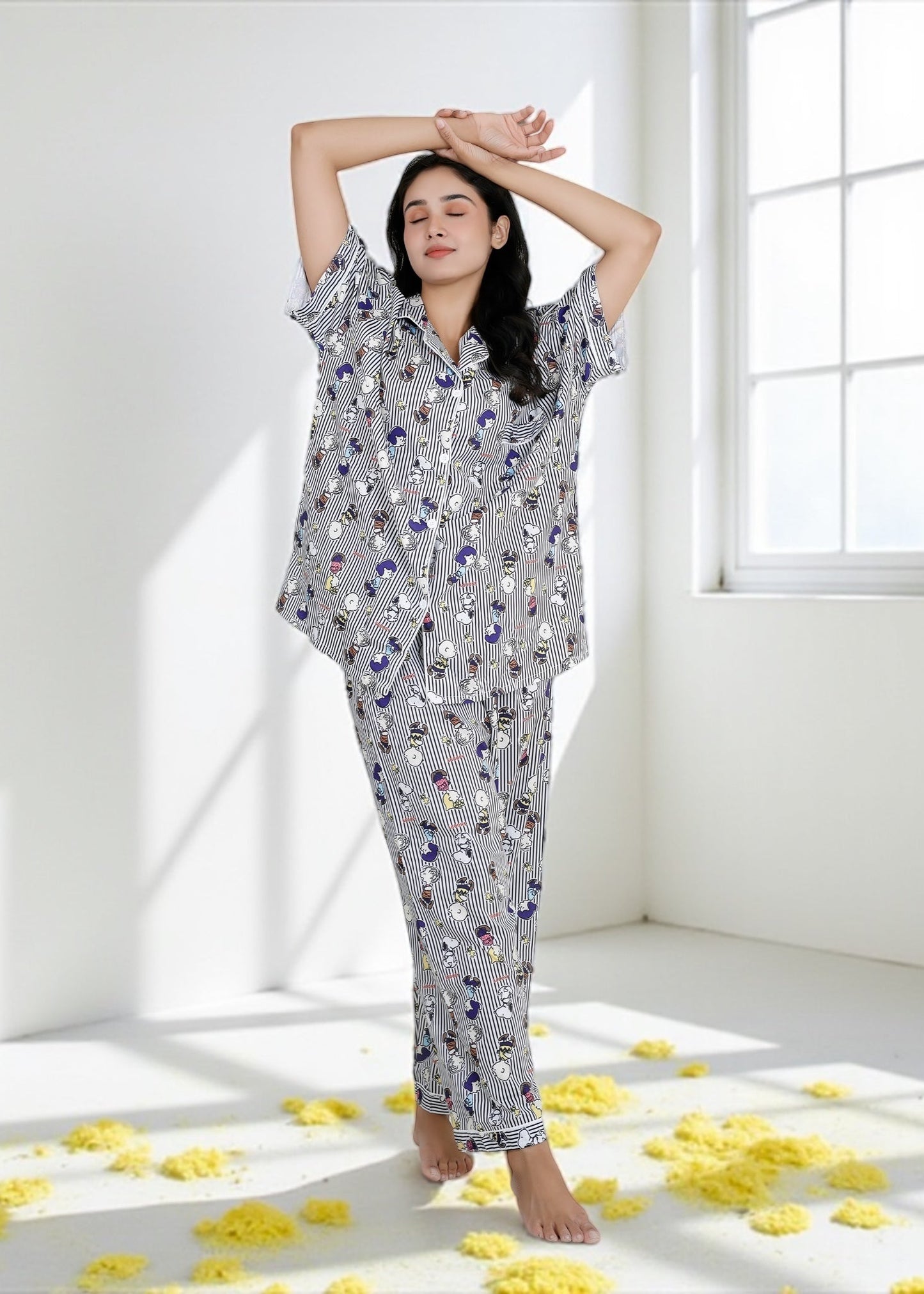 Woman wearing Snoopy cartoon black-and-white striped crepe pyjama set with relaxed fit, stylish nightwear by WakeUp Chicq.