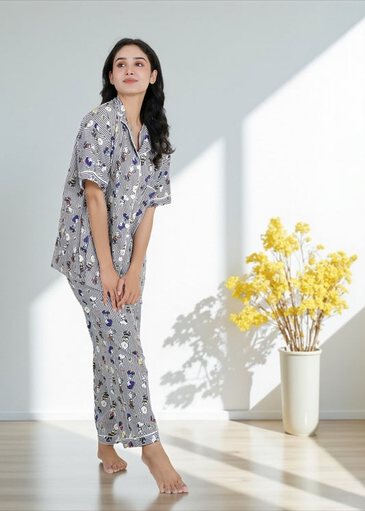 Woman wearing Snoopy cartoon black-and-white striped crepe pyjama set with relaxed fit, stylish nightwear by WakeUp Chicq.