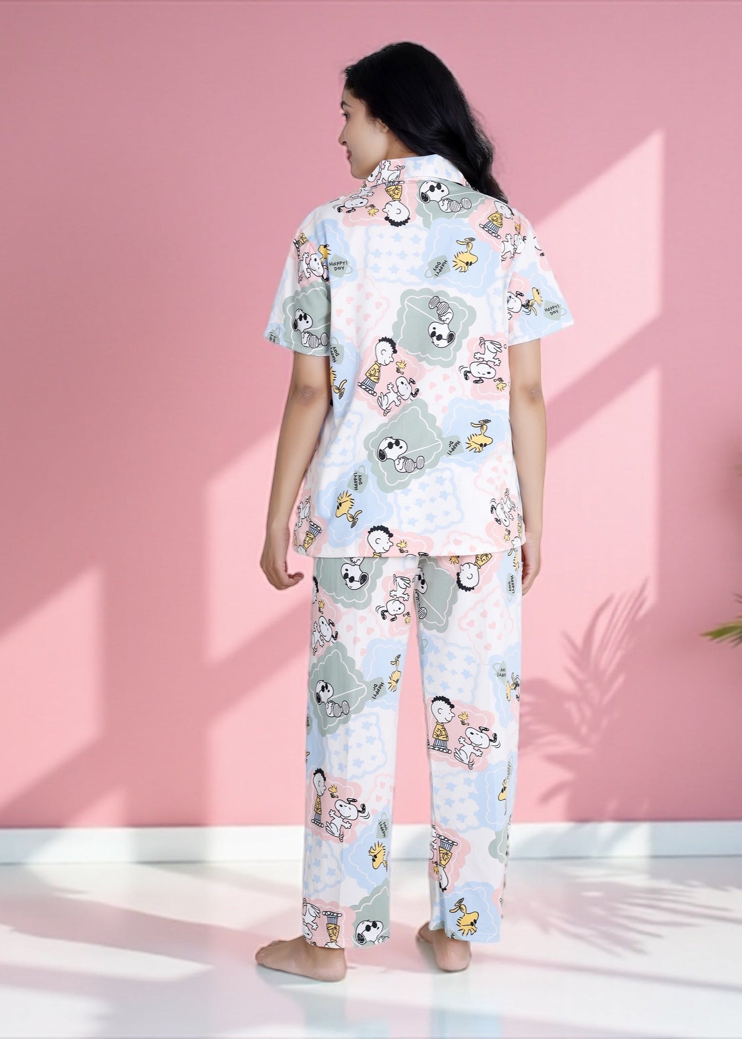 Woman wearing pastel patchwork Snoopy Peanuts cartoon print crushed crepe pyjama set, soft cotton loungewear by WakeUp Chicq.