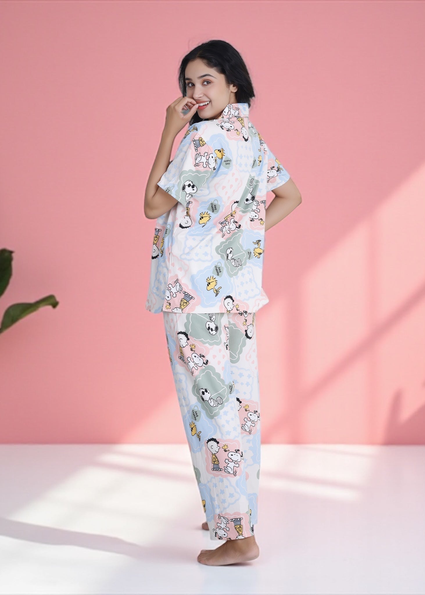 Woman wearing pastel patchwork Snoopy Peanuts cartoon print crushed crepe pyjama set, soft cotton loungewear by WakeUp Chicq.