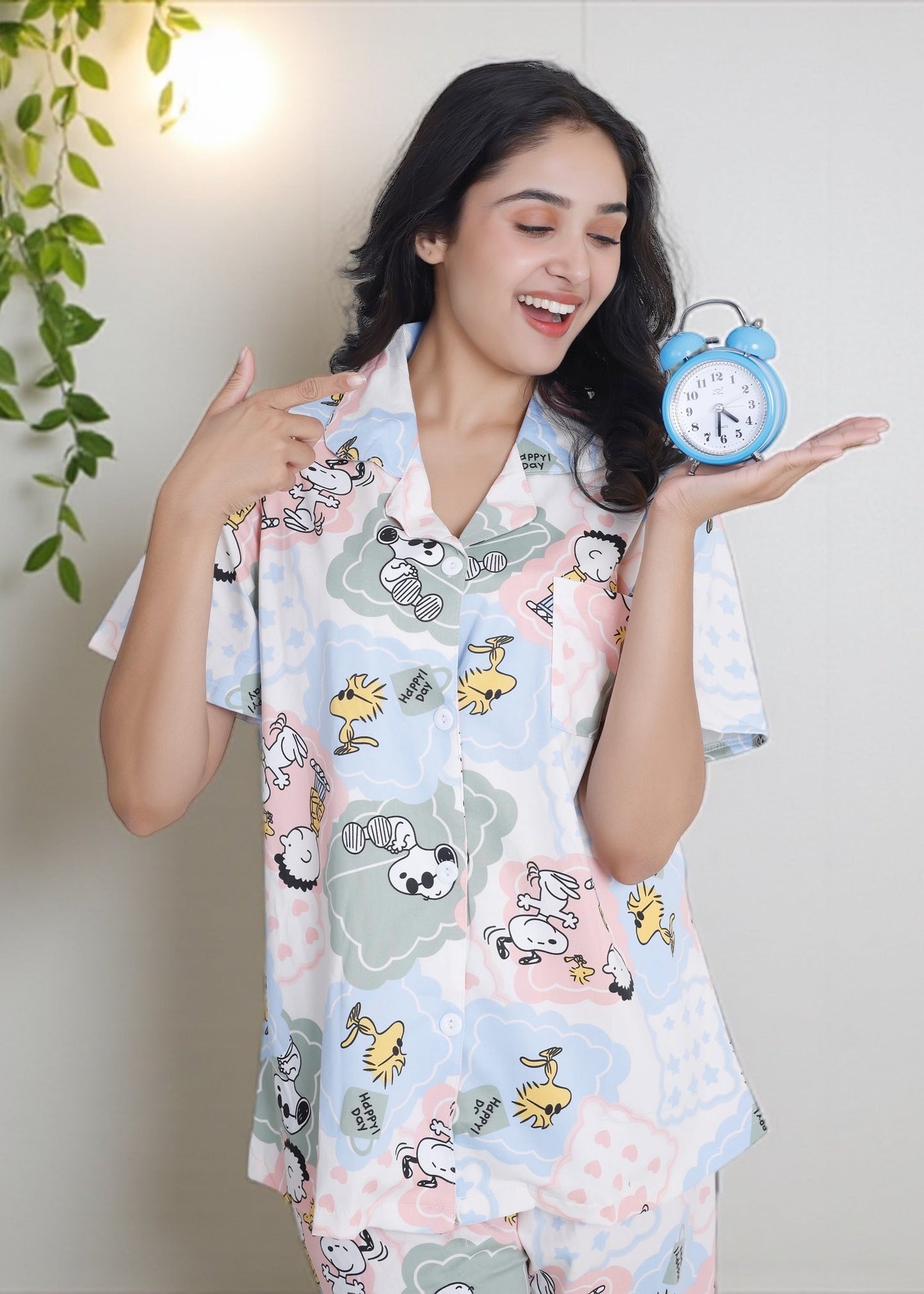 Woman wearing pastel patchwork Snoopy Peanuts cartoon print crushed crepe pyjama set, soft cotton loungewear by WakeUp Chicq.
