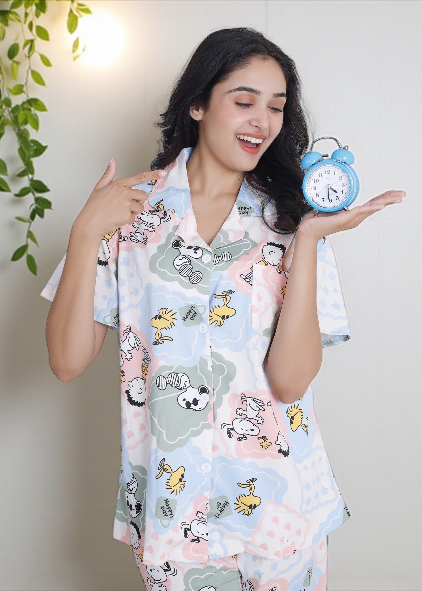 Woman wearing pastel patchwork Snoopy Peanuts cartoon print crushed crepe pyjama set, soft cotton loungewear by WakeUp Chicq.