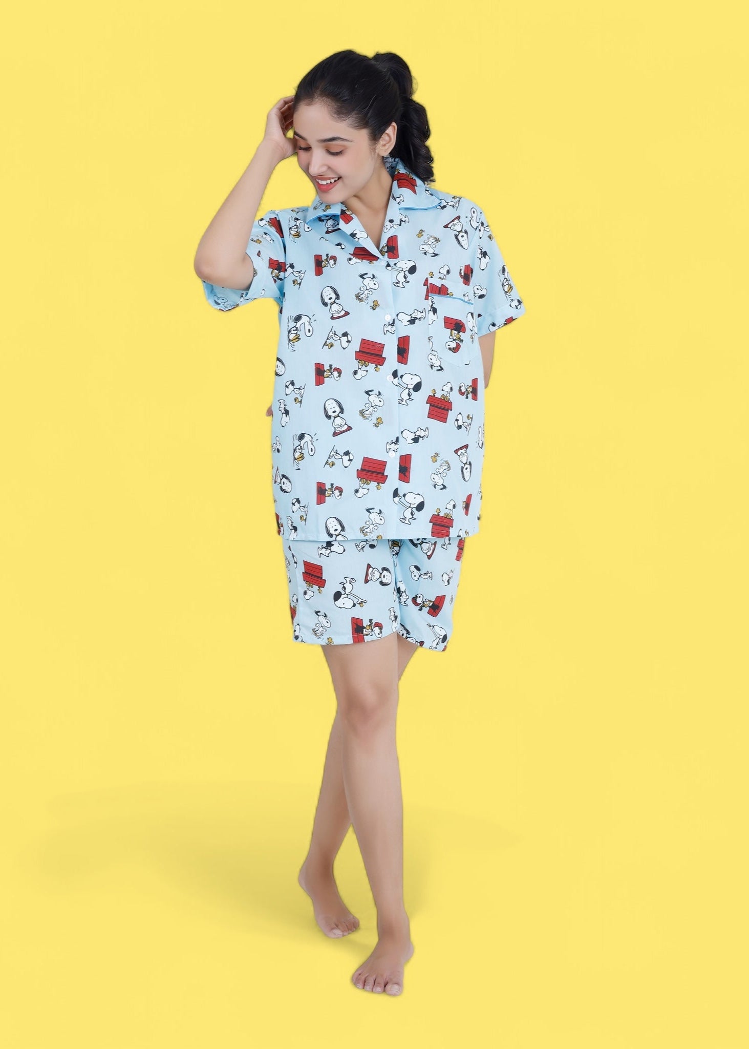 Woman in pastel blue cotton shorts set with Snoopy cartoon print, relaxed loungewear by WakeUp Chicq.