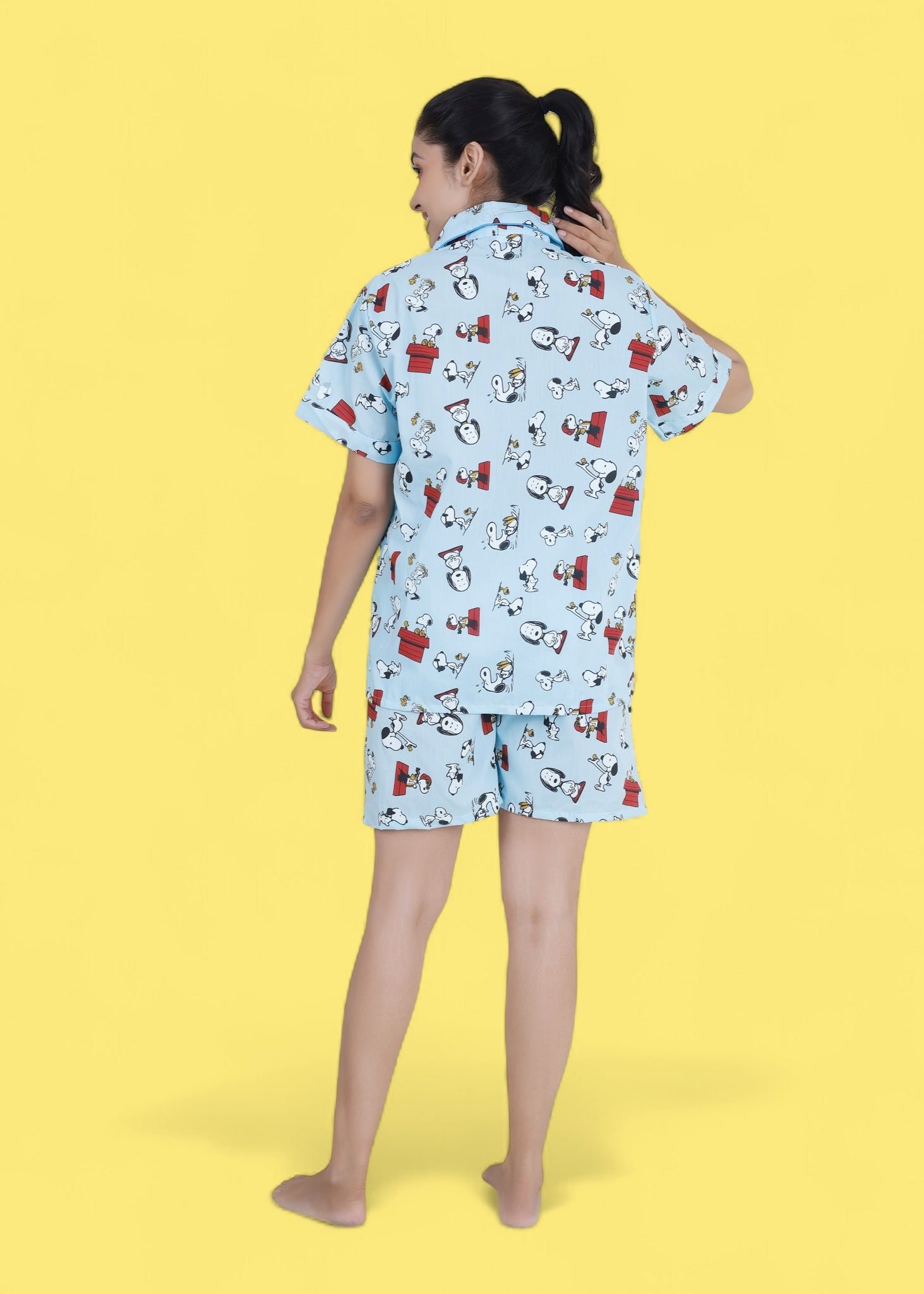 Woman in pastel blue cotton shorts set with Snoopy cartoon print, relaxed loungewear by WakeUp Chicq.
