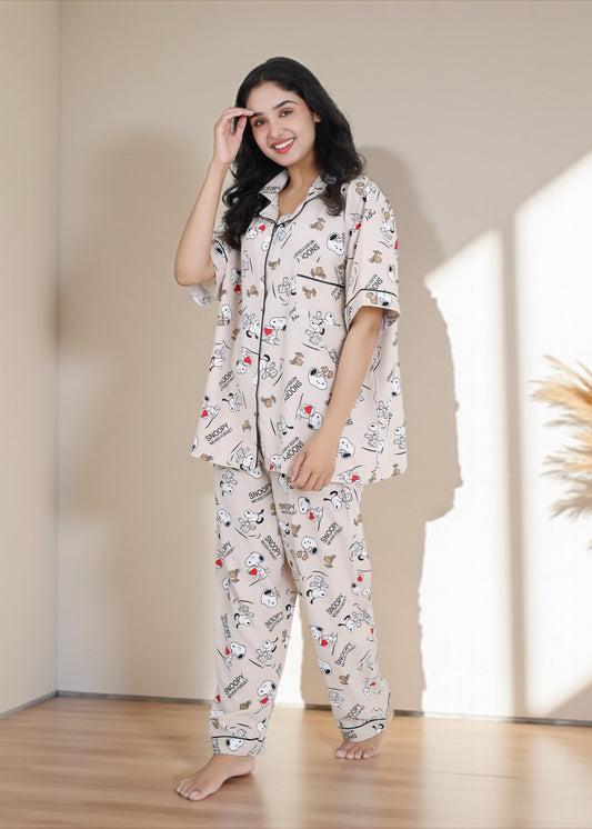 Woman wearing beige crepe cotton pyjama set with Snoopy cartoon print and relaxed oversized fit, by WakeUp Chicq.