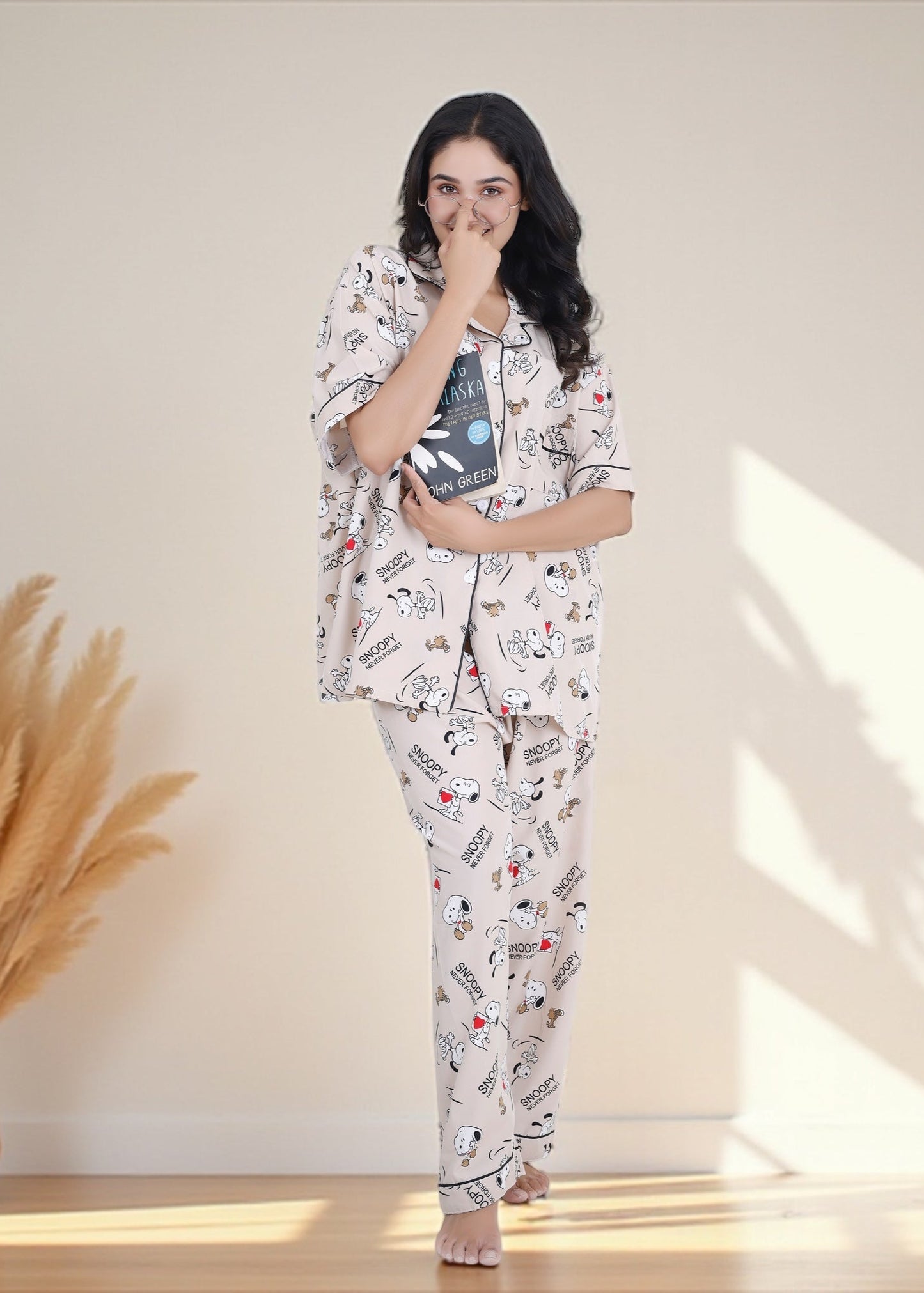 Woman wearing beige crepe cotton pyjama set with Snoopy cartoon print and relaxed oversized fit, by WakeUp Chicq.