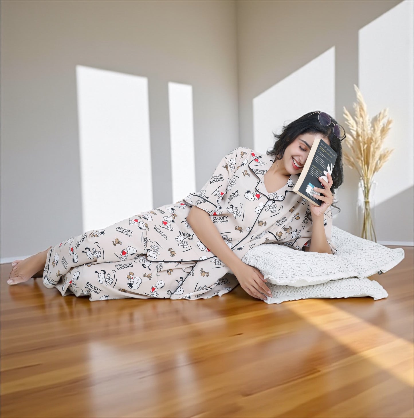 Woman wearing beige crepe cotton pyjama set with Snoopy cartoon print and relaxed oversized fit, by WakeUp Chicq.