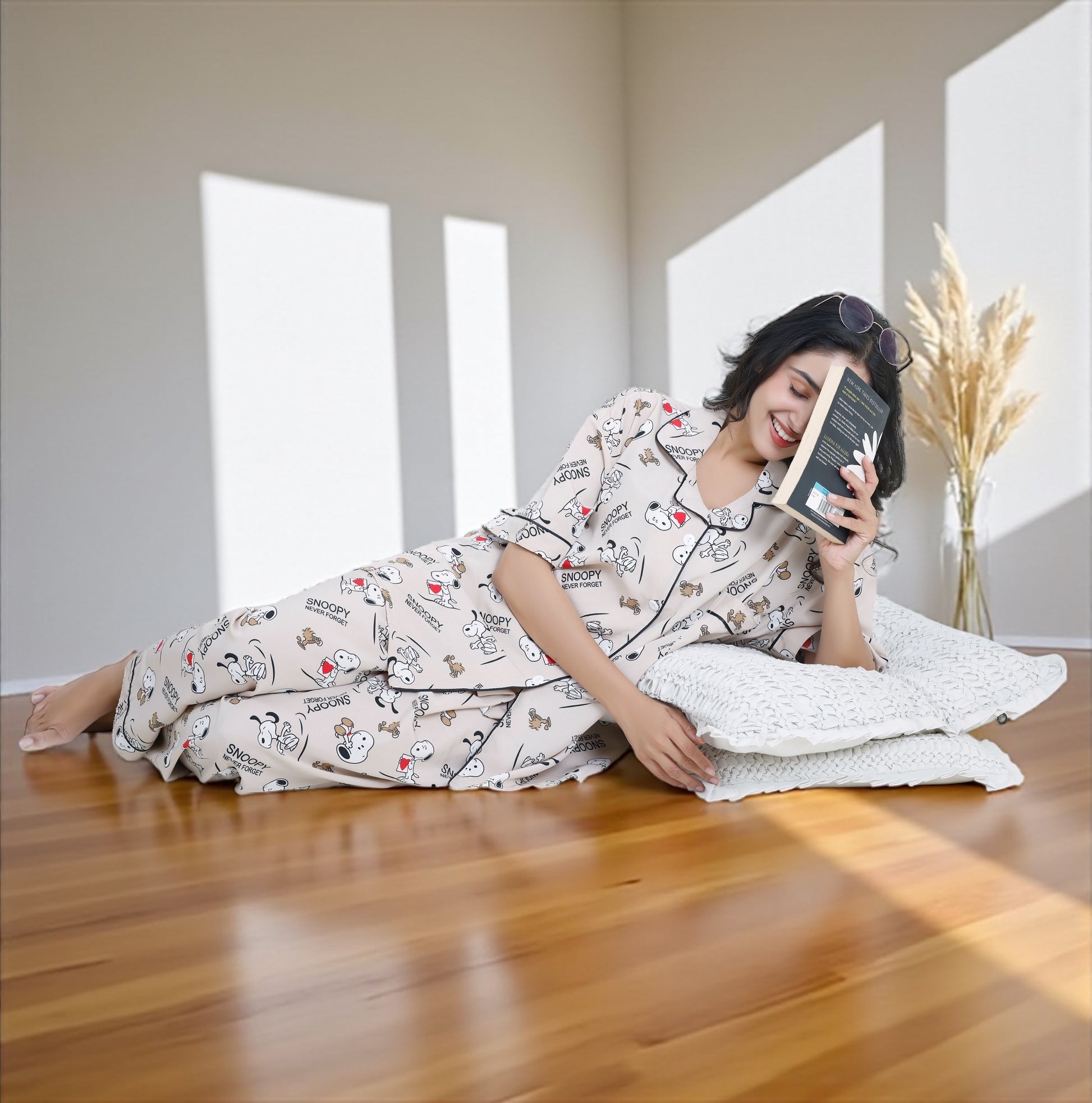 Woman wearing beige crepe cotton pyjama set with Snoopy cartoon print and relaxed oversized fit, by WakeUp Chicq.