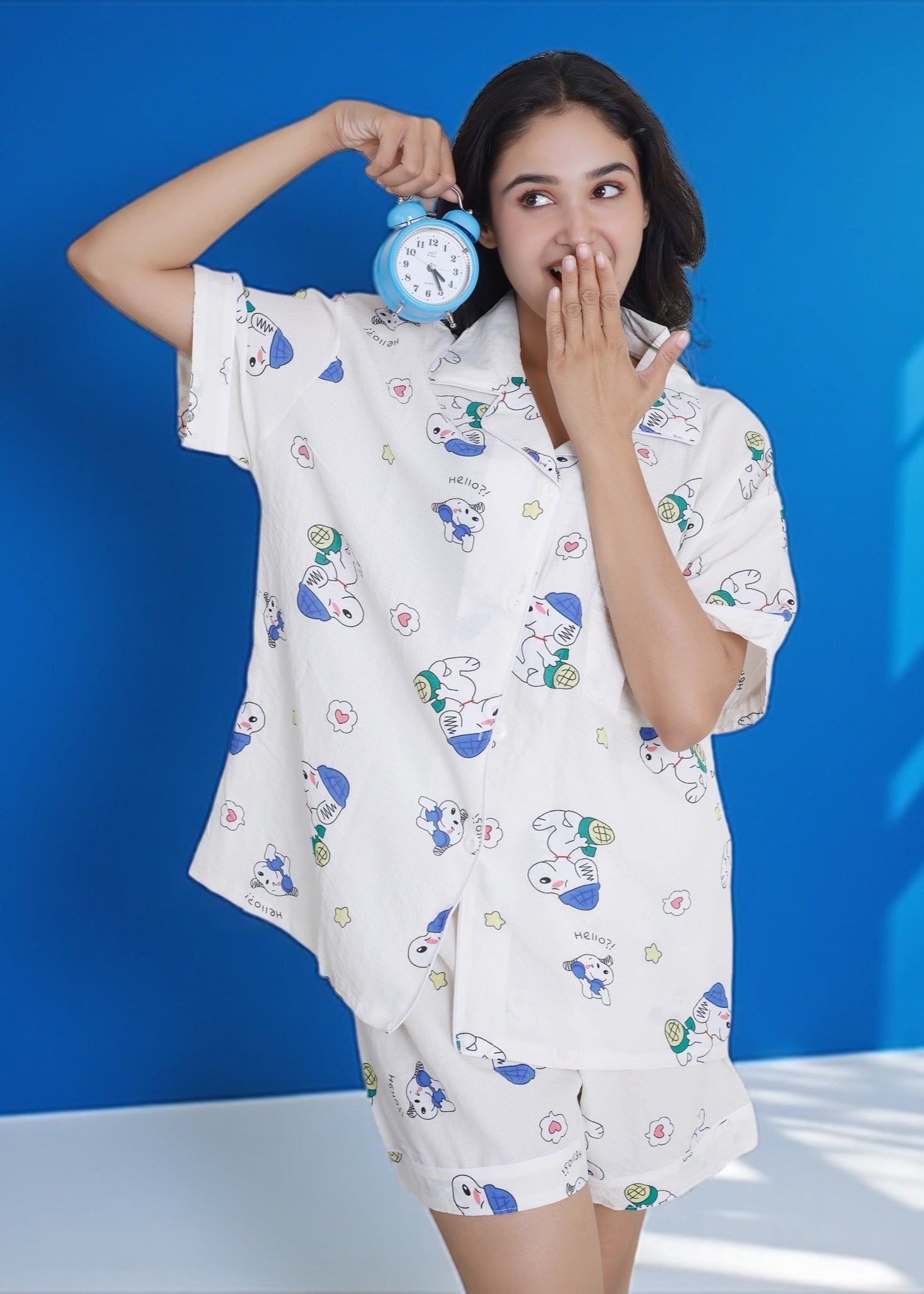 Woman wearing white crushed crepe shorts set with blue and green Snoopy cartoon print, lightweight cotton loungewear by WakeUp Chicq.