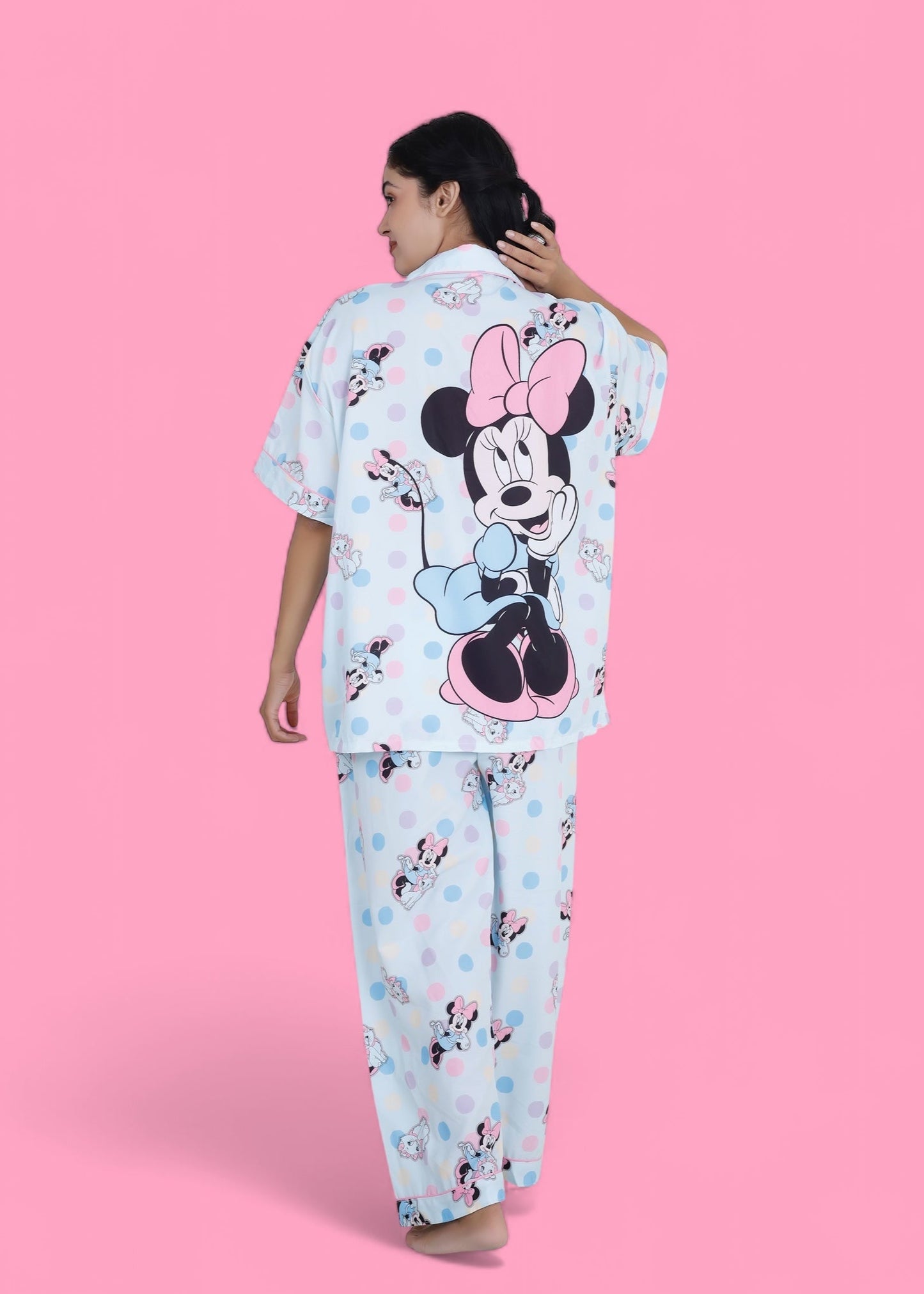 Woman in pastel blue cotton nightwear set featuring Minnie Mouse and cat print, relaxed-fit pyjamas by WakeUp Chicq.