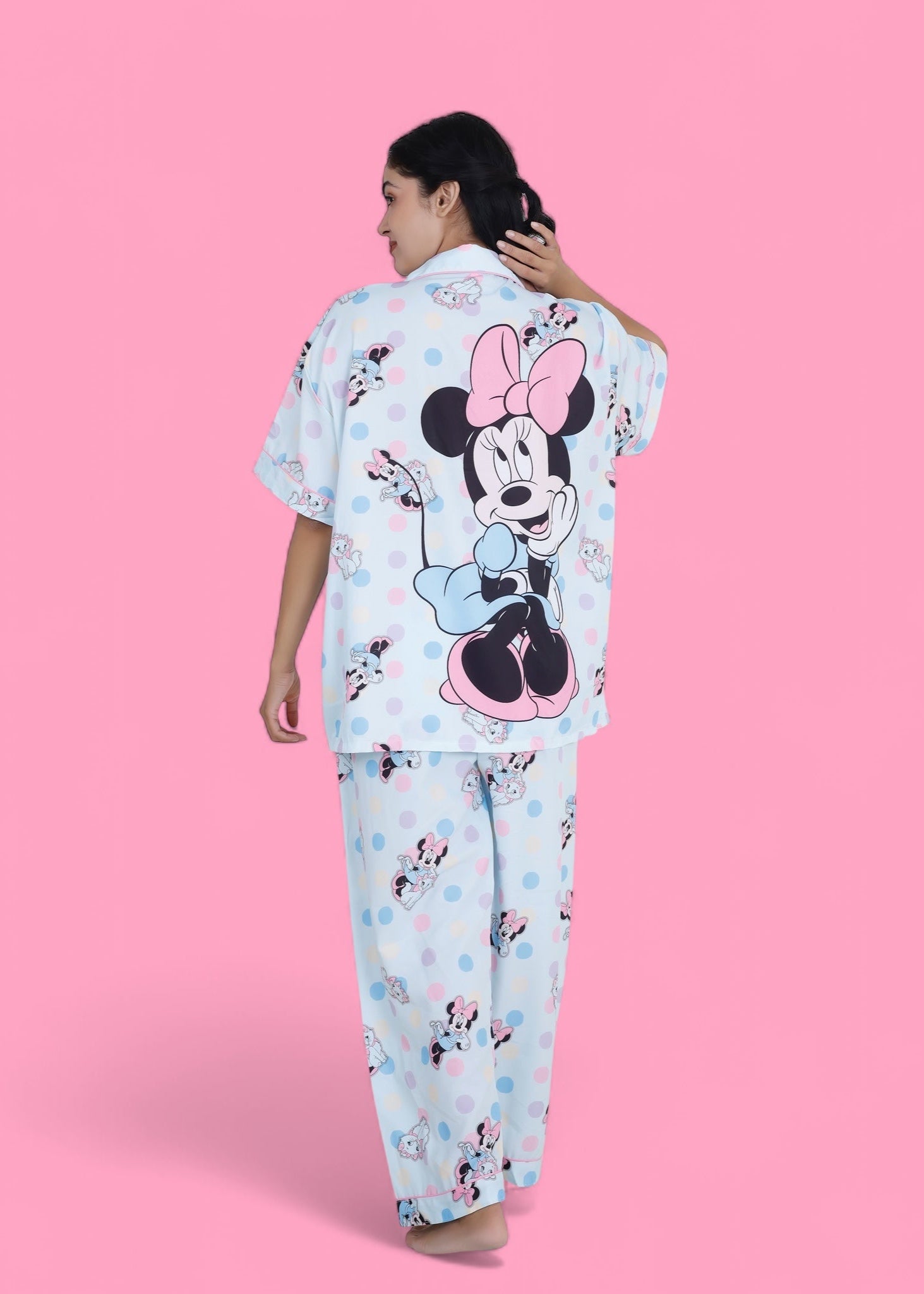 Woman in pastel blue cotton nightwear set featuring Minnie Mouse and cat print, relaxed-fit pyjamas by WakeUp Chicq.