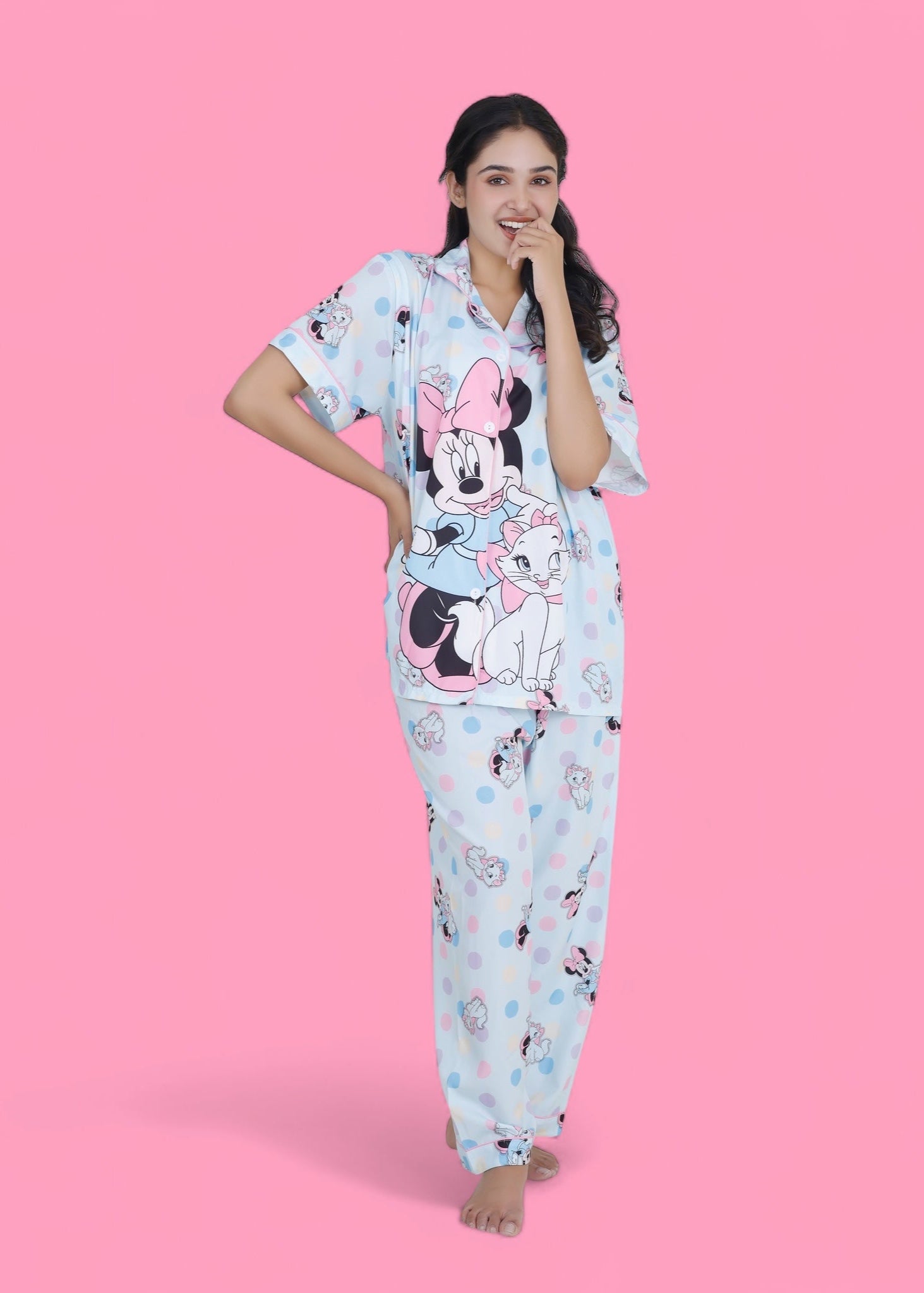 Woman in pastel blue cotton nightwear set featuring Minnie Mouse and cat print, relaxed-fit pyjamas by WakeUp Chicq.