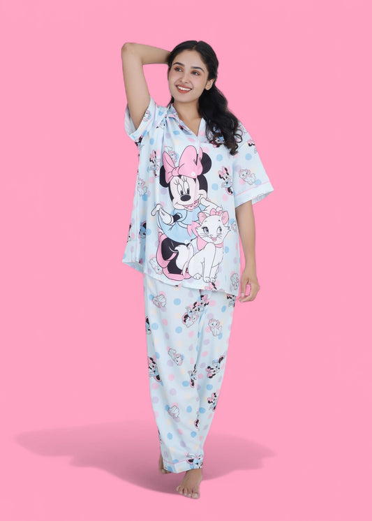 Woman in pastel blue cotton nightwear set featuring Minnie Mouse and cat print, relaxed-fit pyjamas by WakeUp Chicq.
