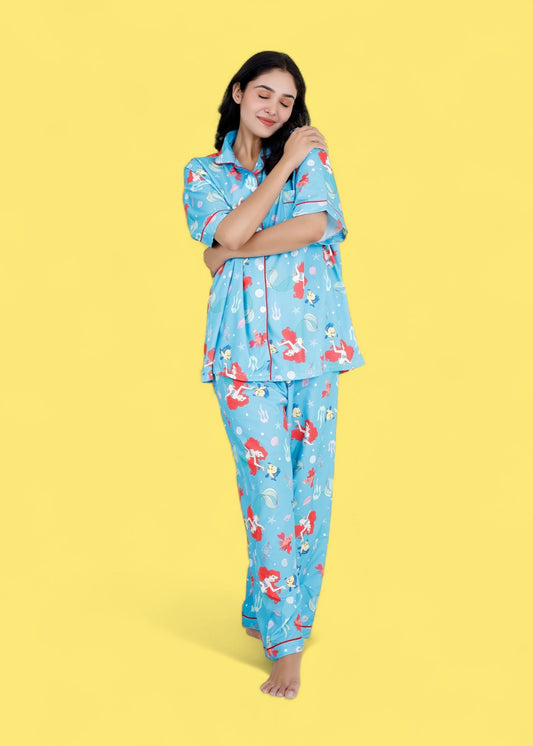 Woman wearing Little Mermaid blue satin pyjama set with underwater mermaid prints

