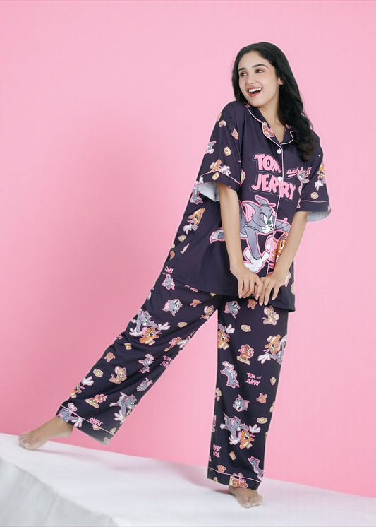 Woman wearing oversized black crepe pyjama set with Tom & Jerry cartoon print, full-sleeve nightwear by WakeUp Chicq.