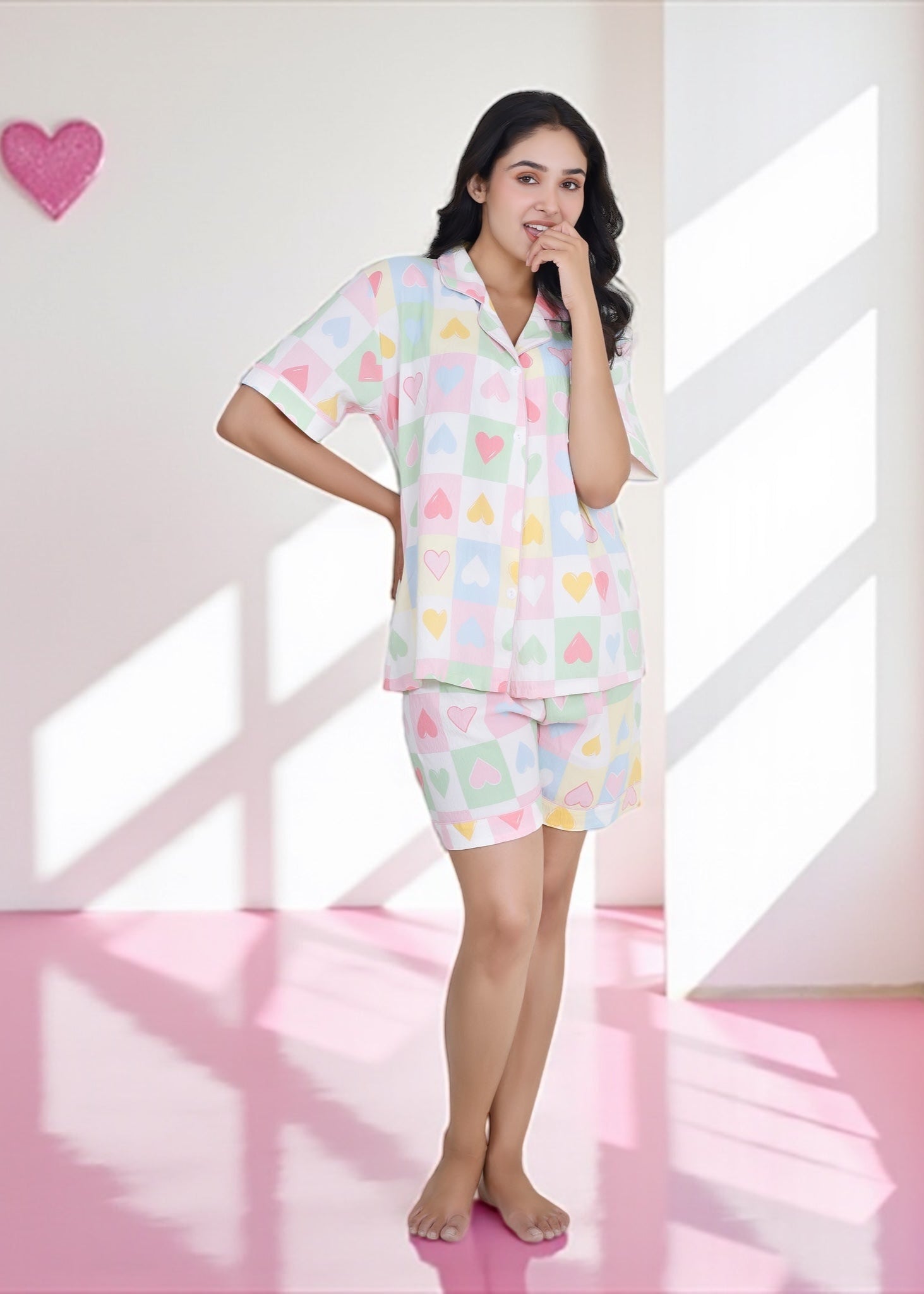 Woman wearing pastel multicolor heart cotton shorts set with notched collar shirt, relaxed loungewear by WakeUp Chicq.


