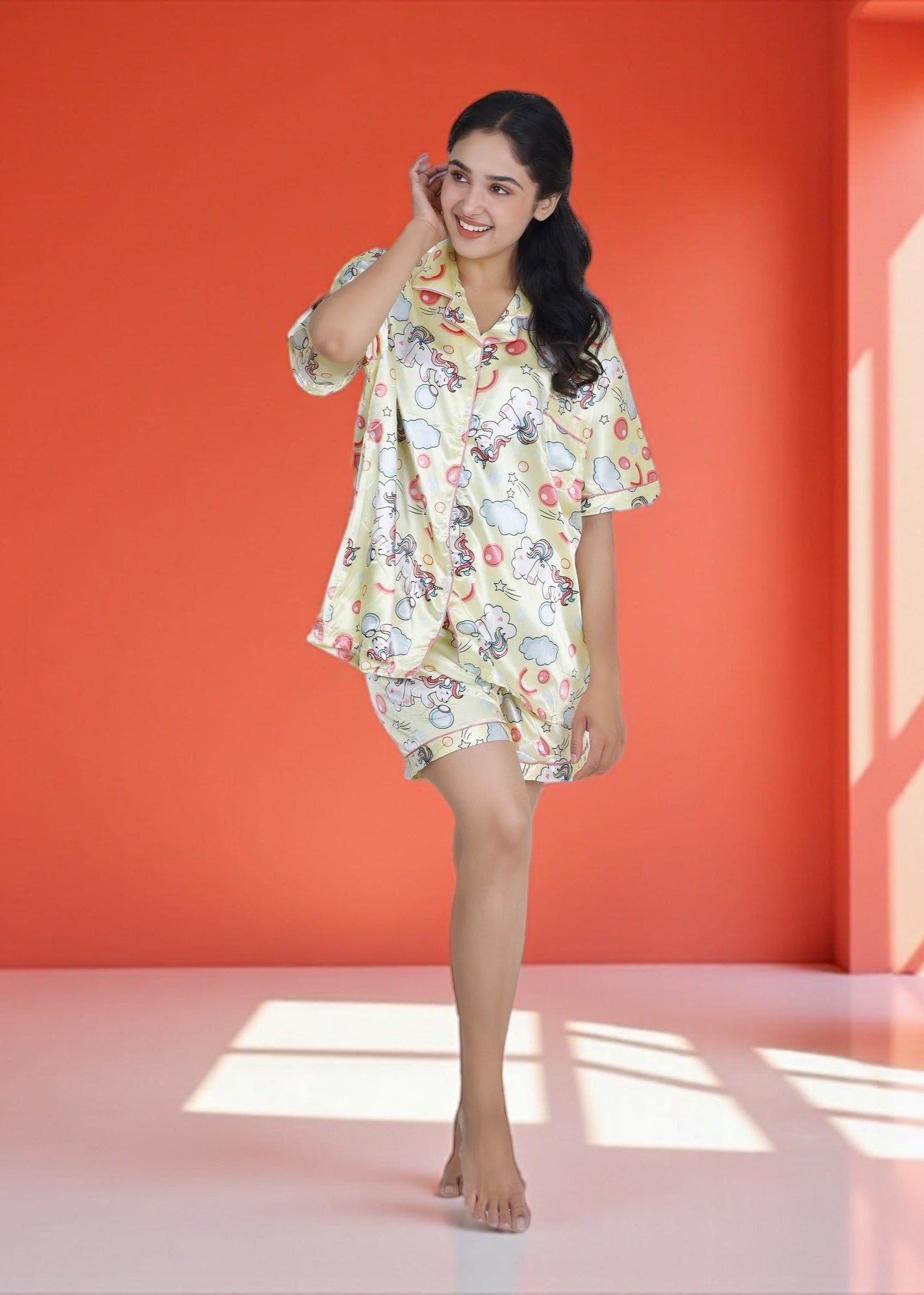 Woman wearing pastel yellow satin unicorn shorts set with black piping, whimsical luxury loungewear by WakeUp Chicq.

