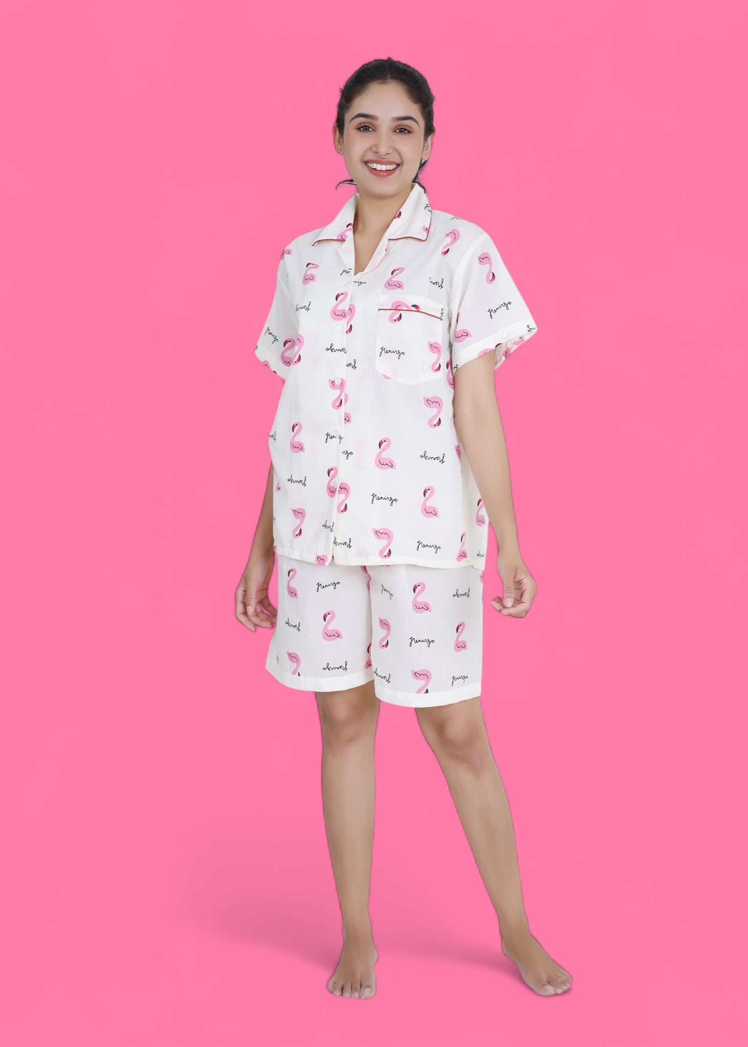 Woman wearing white cotton shorts set with pink flamingo print, lightweight summer loungewear by WakeUp Chicq.