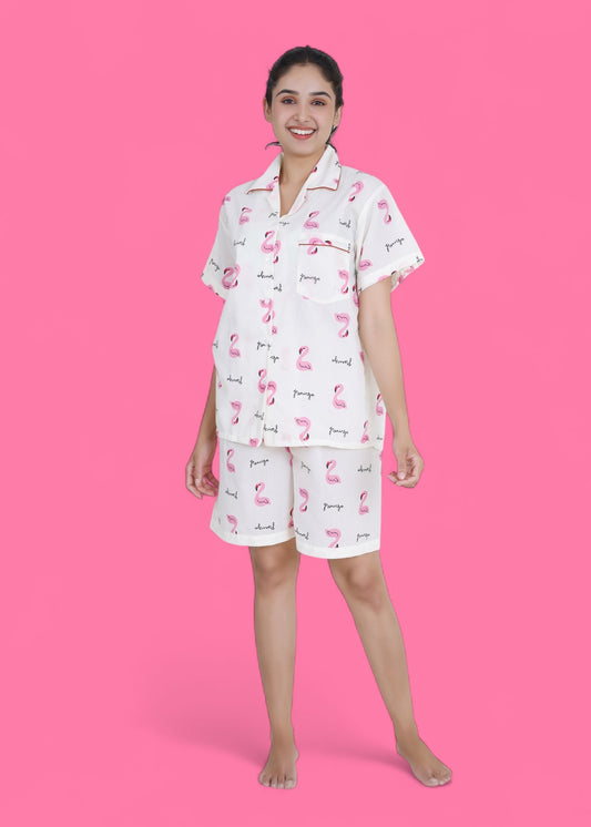 Woman wearing white cotton shorts set with pink flamingo print, lightweight summer loungewear by WakeUp Chicq.