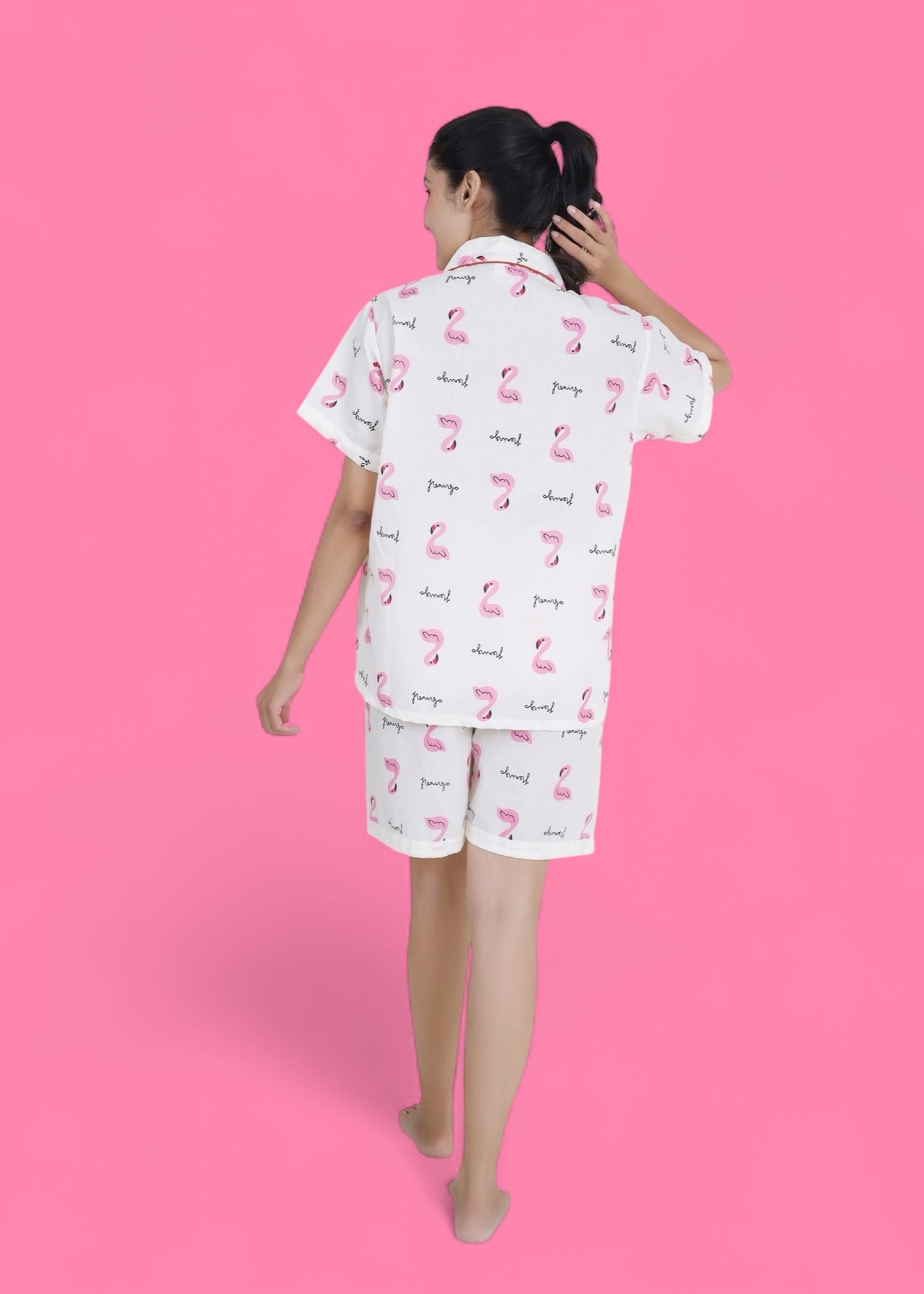 Woman wearing white cotton shorts set with pink flamingo print, lightweight summer loungewear by WakeUp Chicq.