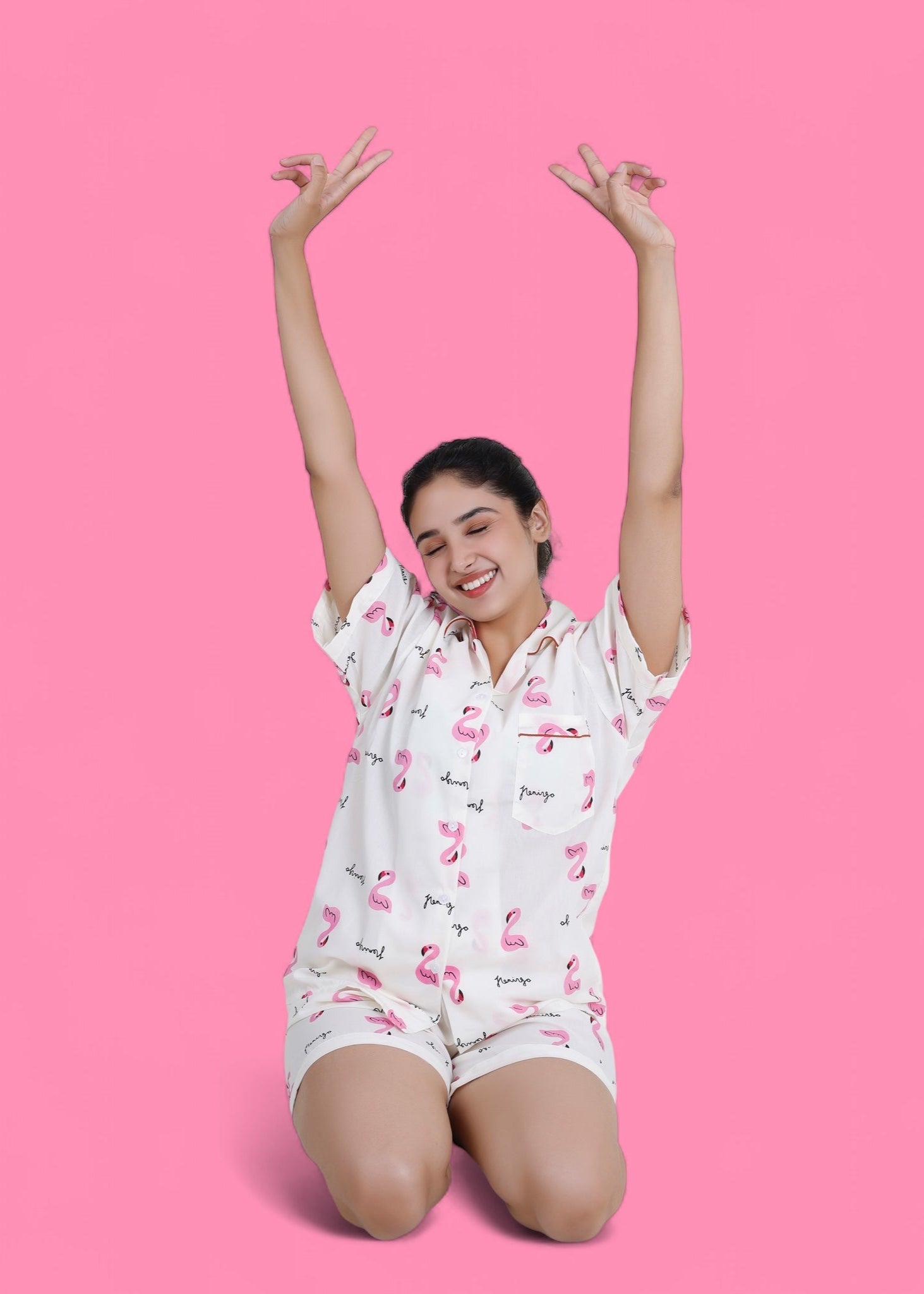 Woman wearing white cotton shorts set with pink flamingo print, lightweight summer loungewear by WakeUp Chicq.