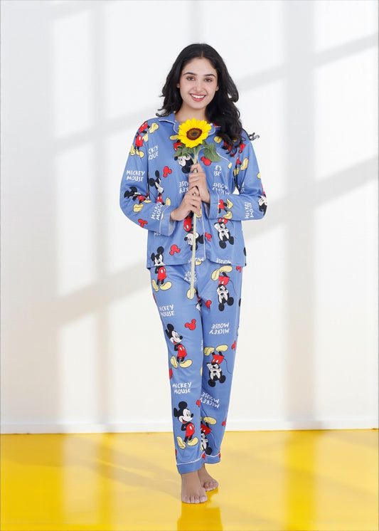Woman wearing light blue jersey cotton pyjama set with Mickey Mouse print and red piping, Disney-inspired loungewear by WakeUp Chicq.

