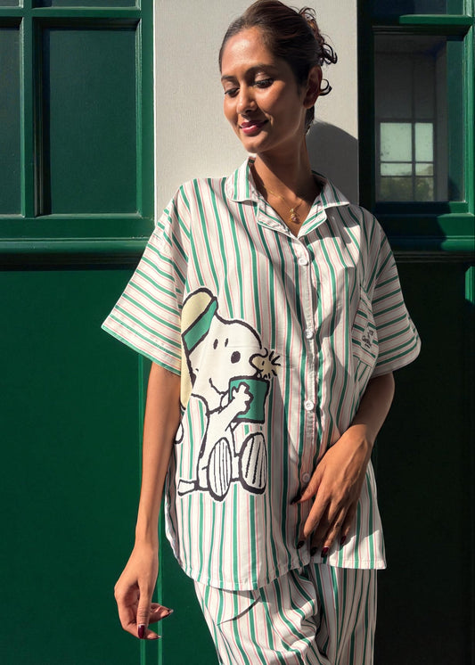 Model wearing WakeUp Chicq’s Big Snoopy Green & White Striped Pyjama Set — silky crepe nightwear with Snoopy print and green-white stripes.