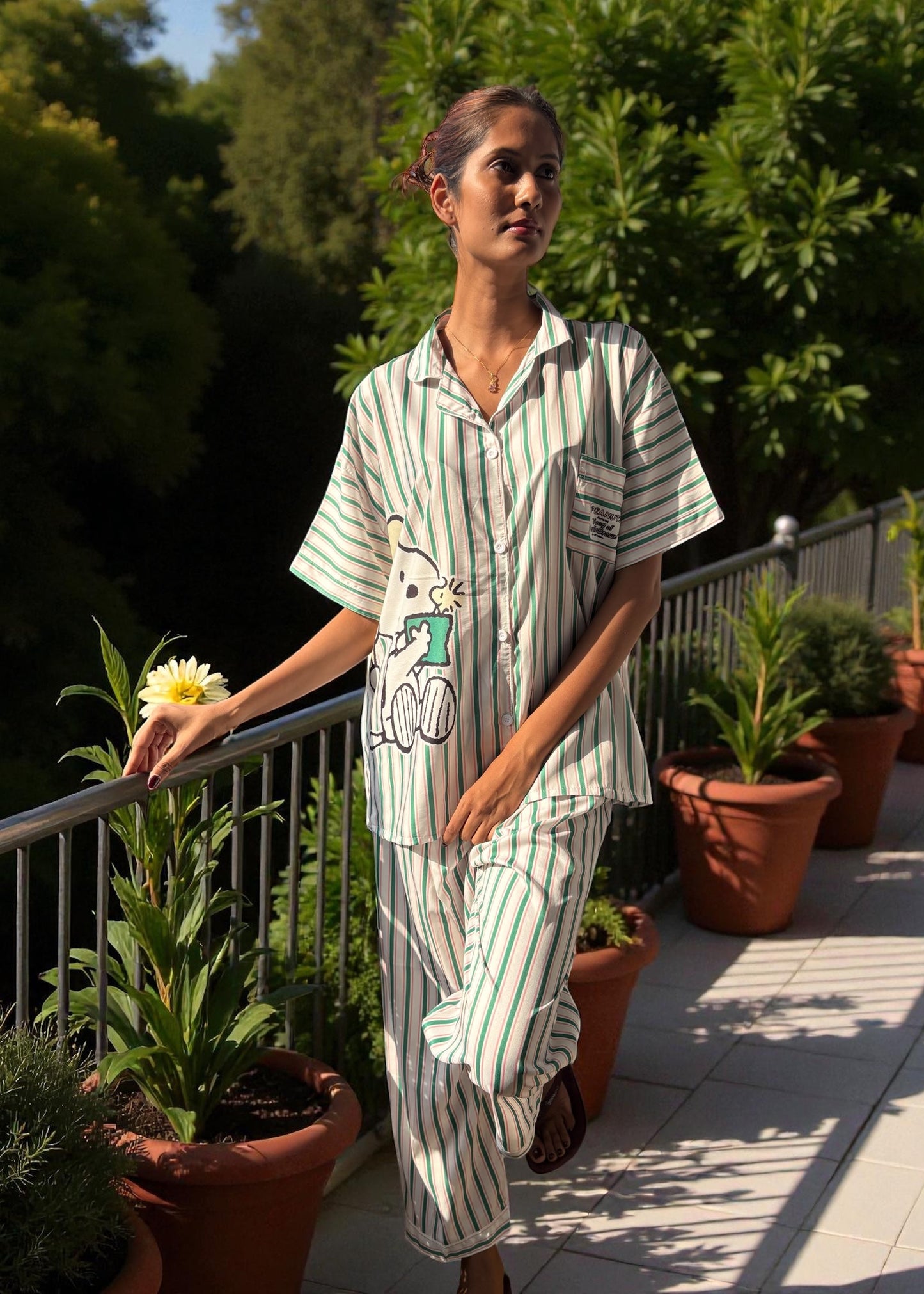 Model wearing WakeUp Chicq’s Big Snoopy Green & White Striped Pyjama Set — silky crepe nightwear with Snoopy print and green-white stripes.