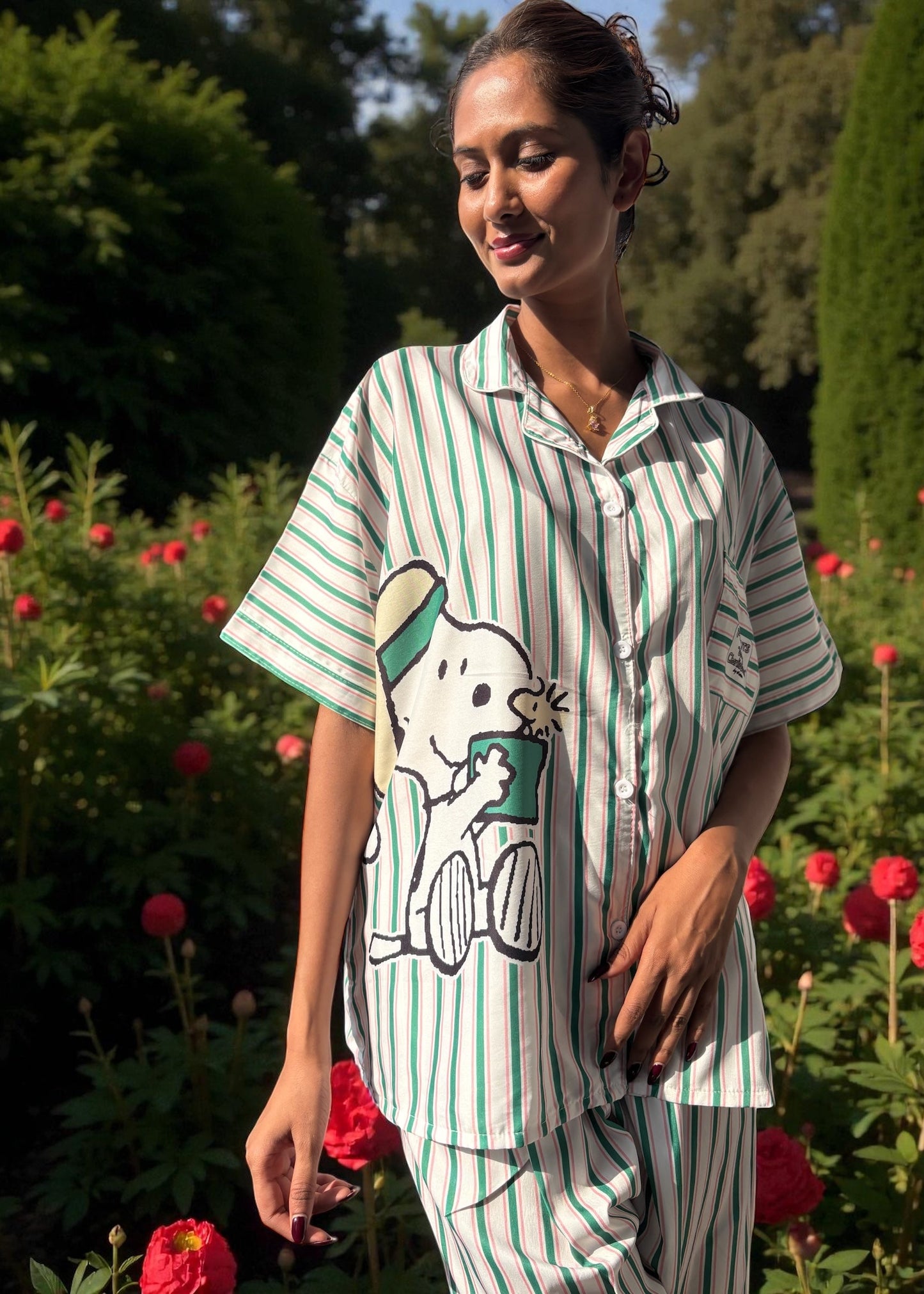 Model wearing WakeUp Chicq’s Big Snoopy Green & White Striped Pyjama Set — silky crepe nightwear with Snoopy print and green-white stripes.