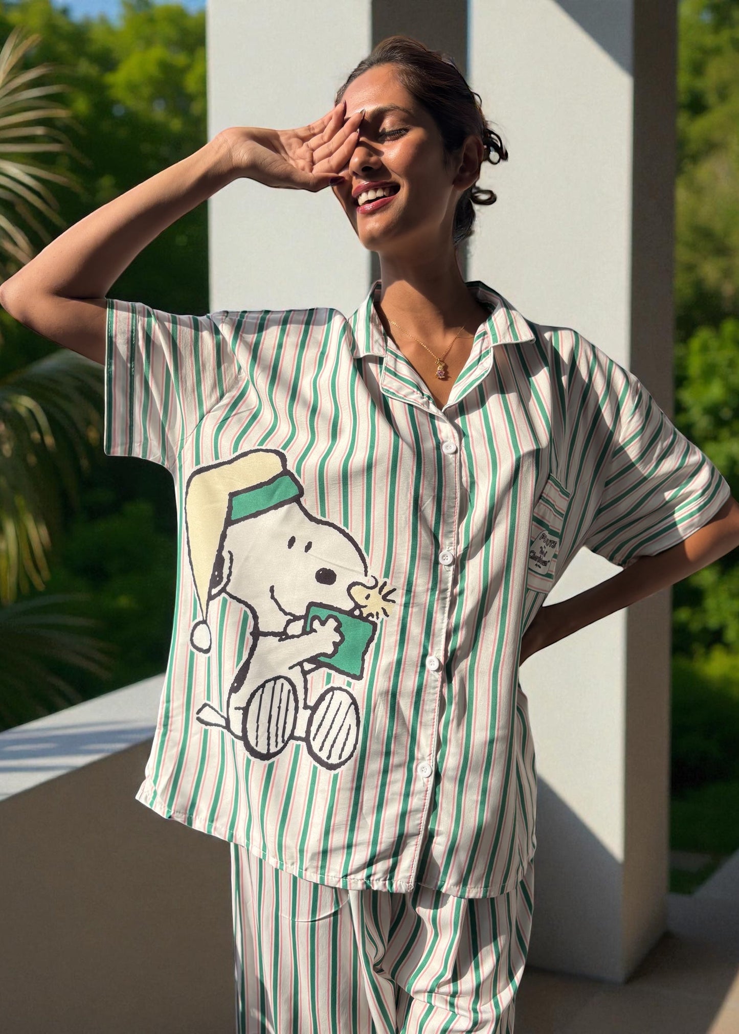 Model wearing WakeUp Chicq’s Big Snoopy Green & White Striped Pyjama Set — silky crepe nightwear with Snoopy print and green-white stripes.