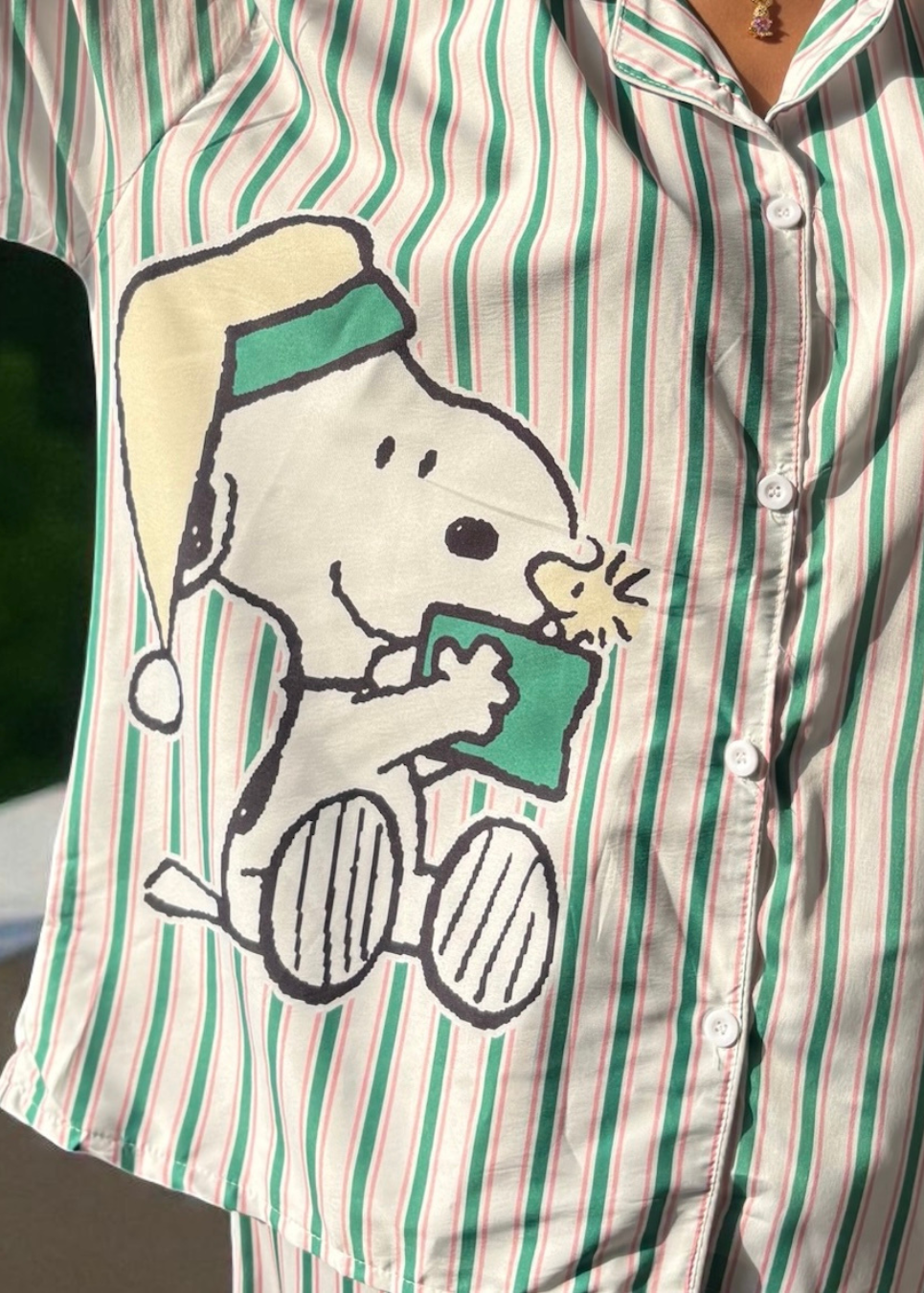 Model wearing WakeUp Chicq’s Big Snoopy Green & White Striped Pyjama Set — silky crepe nightwear with Snoopy print and green-white stripes.